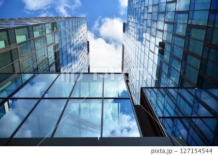 Modern sustainable glass office buildings. Exterior view of corporate headquarters glass buildings architecture.Glass windows in energy-efficient buildings. Financial business center buildings.  127154544