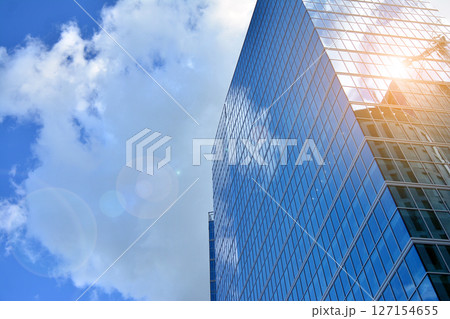 Modern sustainable glass office buildings. Exterior view of corporate headquarters glass buildings architecture.Glass windows in energy-efficient buildings. Financial business center buildings.  127154655