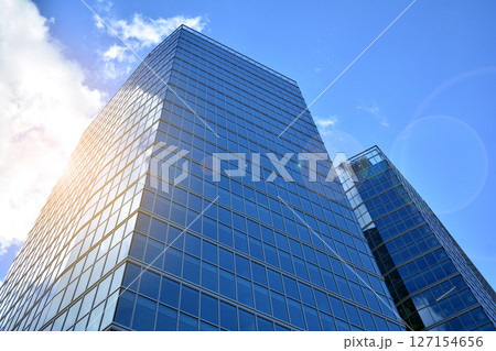 Modern sustainable glass office buildings. Exterior view of corporate headquarters glass buildings architecture.Glass windows in energy-efficient buildings. Financial business center buildings.  127154656