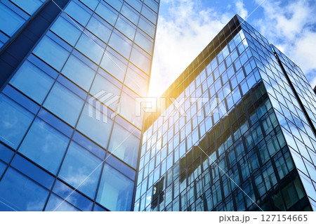 Modern sustainable glass office buildings. Exterior view of corporate headquarters glass buildings architecture.Glass windows in energy-efficient buildings. Financial business center buildings.  127154665