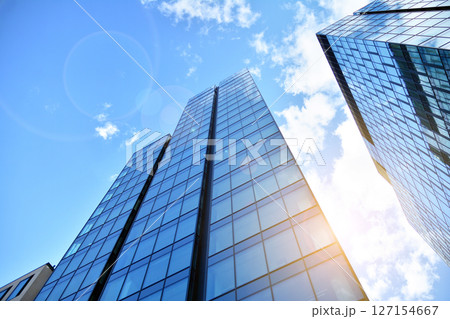 Modern sustainable glass office buildings. Exterior view of corporate headquarters glass buildings architecture.Glass windows in energy-efficient buildings. Financial business center buildings.  Modern sustainable glass office buildings. Exterior view of corporate headquarters glass buildings architecture.Glass windows in energy-efficient buildings. Financial business center buildings.  127154667