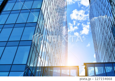 Modern sustainable glass office buildings. Exterior view of corporate headquarters glass buildings architecture.Glass windows in energy-efficient buildings. Financial business center buildings.  127154668