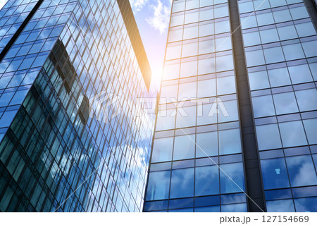 Modern sustainable glass office buildings. Exterior view of corporate headquarters glass buildings architecture.Glass windows in energy-efficient buildings. Financial business center buildings. Modern sustainable glass office buildings. Exterior view of corporate headquarters glass buildings architecture.Glass windows in energy-efficient buildings. Financial business center buildings. 127154669