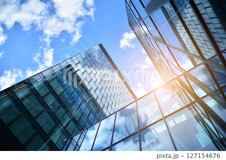 Modern sustainable glass office buildings. Exterior view of corporate headquarters glass buildings architecture.Glass windows in energy-efficient buildings. Financial business center buildings. Modern sustainable glass office buildings. Exterior view of corporate headquarters glass buildings architecture.Glass windows in energy-efficient buildings. Financial business center buildings. 127154676