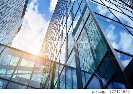 Modern sustainable glass office buildings. Exterior view of corporate headquarters glass buildings architecture.Glass windows in energy-efficient buildings. Financial business center buildings.  127154679