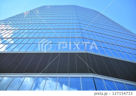 Modern sustainable glass office buildings. Exterior view of corporate headquarters glass buildings architecture.Glass windows in energy-efficient buildings. Financial business center buildings.  127154713