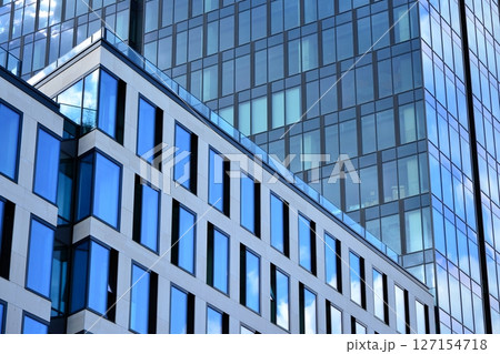Modern sustainable glass office buildings. Exterior view of corporate headquarters glass buildings architecture.Glass windows in energy-efficient buildings. Financial business center buildings. Modern sustainable glass office buildings. Exterior view of corporate headquarters glass buildings architecture.Glass windows in energy-efficient buildings. Financial business center buildings. 127154718