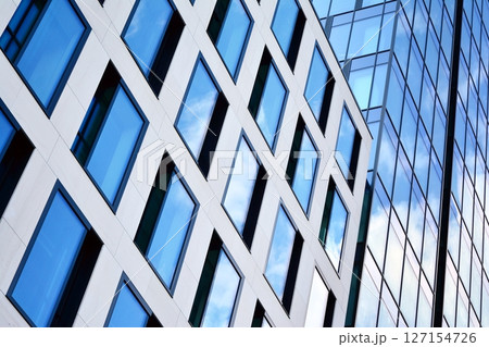 Modern sustainable glass office buildings. Exterior view of corporate headquarters glass buildings architecture.Glass windows in energy-efficient buildings. Financial business center buildings.  127154726