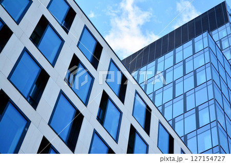 Modern sustainable glass office buildings. Exterior view of corporate headquarters glass buildings architecture.Glass windows in energy-efficient buildings. Financial business center buildings.  127154727