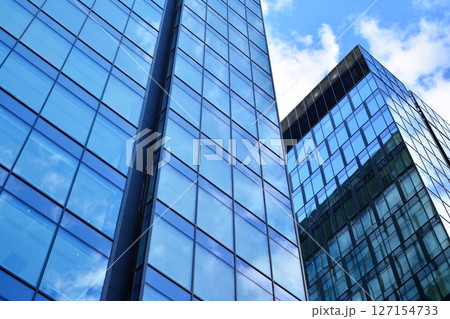 Modern sustainable glass office buildings. Exterior view of corporate headquarters glass buildings architecture.Glass windows in energy-efficient buildings. Financial business center buildings.  127154733