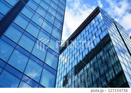 Modern sustainable glass office buildings. Exterior view of corporate headquarters glass buildings architecture.Glass windows in energy-efficient buildings. Financial business center buildings.  127154736