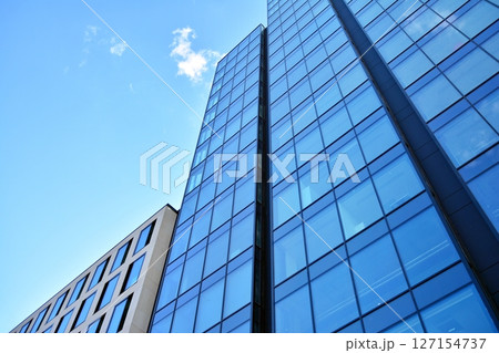 Modern sustainable glass office buildings. Exterior view of corporate headquarters glass buildings architecture.Glass windows in energy-efficient buildings. Financial business center buildings.  127154737