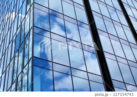 Modern sustainable glass office buildings. Exterior view of corporate headquarters glass buildings architecture.Glass windows in energy-efficient buildings. Financial business center buildings.  127154743