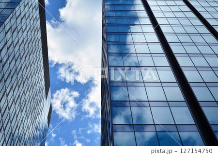 Modern sustainable glass office buildings. Exterior view of corporate headquarters glass buildings architecture.Glass windows in energy-efficient buildings. Financial business center buildings. Modern sustainable glass office buildings. Exterior view of corporate headquarters glass buildings architecture.Glass windows in energy-efficient buildings. Financial business center buildings. 127154750