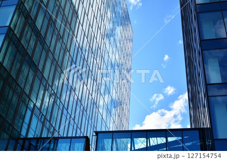 Modern sustainable glass office buildings. Exterior view of corporate headquarters glass buildings architecture.Glass windows in energy-efficient buildings. Financial business center buildings. Modern sustainable glass office buildings. Exterior view of corporate headquarters glass buildings architecture.Glass windows in energy-efficient buildings. Financial business center buildings. 127154754