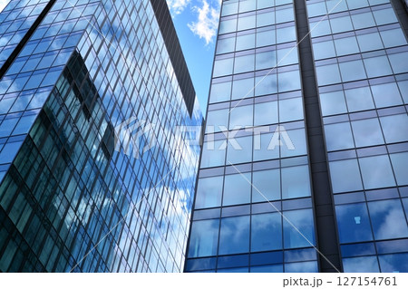 Modern sustainable glass office buildings. Exterior view of corporate headquarters glass buildings architecture.Glass windows in energy-efficient buildings. Financial business center buildings. Modern sustainable glass office buildings. Exterior view of corporate headquarters glass buildings architecture.Glass windows in energy-efficient buildings. Financial business center buildings. 127154761