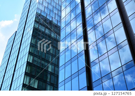 Modern sustainable glass office buildings. Exterior view of corporate headquarters glass buildings architecture.Glass windows in energy-efficient buildings. Financial business center buildings.  127154765