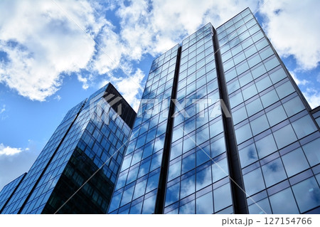 Modern sustainable glass office buildings. Exterior view of corporate headquarters glass buildings architecture.Glass windows in energy-efficient buildings. Financial business center buildings.  127154766