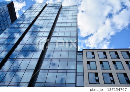 Modern sustainable glass office buildings. Exterior view of corporate headquarters glass buildings architecture.Glass windows in energy-efficient buildings. Financial business center buildings.  127154767