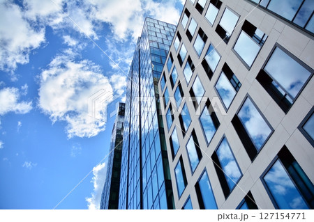 Modern sustainable glass office buildings. Exterior view of corporate headquarters glass buildings architecture.Glass windows in energy-efficient buildings. Financial business center buildings. Modern sustainable glass office buildings. Exterior view of corporate headquarters glass buildings architecture.Glass windows in energy-efficient buildings. Financial business center buildings. 127154771