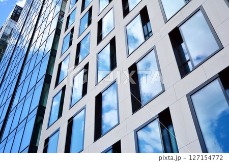 Modern sustainable glass office buildings. Exterior view of corporate headquarters glass buildings architecture.Glass windows in energy-efficient buildings. Financial business center buildings.  127154772