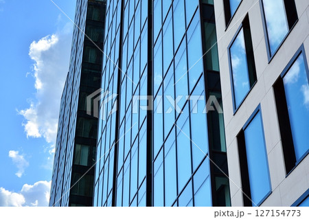 Modern sustainable glass office buildings. Exterior view of corporate headquarters glass buildings architecture.Glass windows in energy-efficient buildings. Financial business center buildings.  127154773