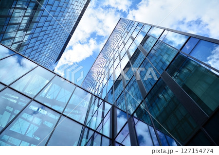 Modern sustainable glass office buildings. Exterior view of corporate headquarters glass buildings architecture.Glass windows in energy-efficient buildings. Financial business center buildings.  127154774