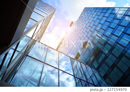 Modern sustainable glass office buildings. Exterior view of corporate headquarters glass buildings architecture.Glass windows in energy-efficient buildings. Financial business center buildings.  127154970