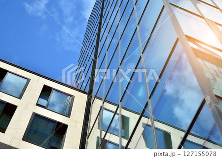 Modern sustainable glass office buildings. Exterior view of corporate headquarters glass buildings architecture.Glass windows in energy-efficient buildings. Financial business center buildings.  127155078