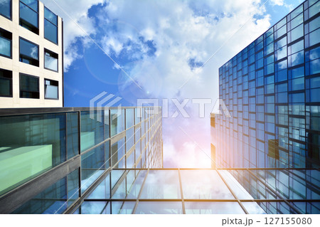 Modern sustainable glass office buildings. Exterior view of corporate headquarters glass buildings architecture.Glass windows in energy-efficient buildings. Financial business center buildings. Modern sustainable glass office buildings. Exterior view of corporate headquarters glass buildings architecture.Glass windows in energy-efficient buildings. Financial business center buildings. 127155080