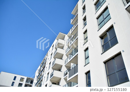 Modern new residential apartment house building complex. Exterior view of modern apartment building. New construction apartment or condo complex. Modern new residential apartment house building complex. Exterior view of modern apartment building. New construction apartment or condo complex. 127155180