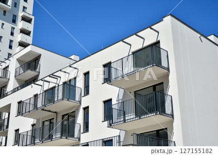 Modern new residential apartment house building complex. Exterior view of modern apartment building. New construction apartment or condo complex. 127155182