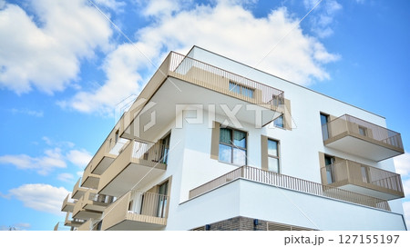 Modern new residential apartment house building complex. Exterior view of modern apartment building. New construction apartment or condo complex. 127155197