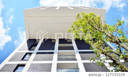 Modern new residential apartment house building complex. Exterior view of modern apartment building. New construction apartment or condo complex. 127155224
