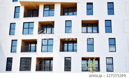 Modern new residential apartment house building complex. Exterior view of modern apartment building. New construction apartment or condo complex. 127155269