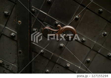 Ornate Handle on Old Metal Door Ornate Handle on Old Metal Door 127155294