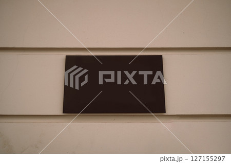 Blank Black Sign on Beige Wall Blank Black Sign on Beige Wall 127155297