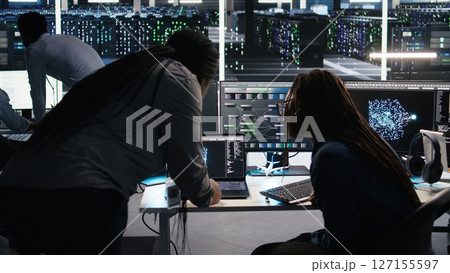 Data center teamworking colleagues use node tree program to identify equipment performance issues. Server hub engineering team coworkers review data analysis graph to minimize failures, camera A Data center teamworking colleagues use node tree program to identify equipment performance issues. Server hub engineering team coworkers review data analysis graph to minimize failures, camera A 127155597