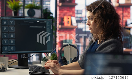 Female freelancer uses online AI assistant to automate text generation and solve tasks easily, enhance productivity at the office. Integration of advanced algorithms and digital tools. Camera B. Female freelancer uses online AI assistant to automate text generation and solve tasks easily, enhance productivity at the office. Integration of advanced algorithms and digital tools. Camera B. 127155615