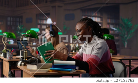 Confident student gathers information and citations from reliable sources via massive database at university library, working on bachelor degree paper. Intelligent girl studies. Camera A. Confident student gathers information and citations from reliable sources via massive database at university library, working on bachelor degree paper. Intelligent girl studies. Camera A. 127155762