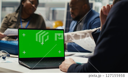 Shareholders use mockup laptop to project returns, assessing deal feasibility. Accountant in office using green screen notebook, performing financial analysis for interested investors Shareholders use mockup laptop to project returns, assessing deal feasibility. Accountant in office using green screen notebook, performing financial analysis for interested investors 127155938