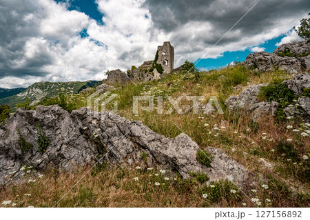 Ruins Of Grad Vipava In Slovenia: Ancient Stone Walls Covered In Ivy Standing On A Grassy Hilltop Under A Dramatic Cloud-Filled Sky In The Scenic Vipava Valley Ruins Of Grad Vipava In Slovenia: Ancient Stone Walls Covered In Ivy Standing On A Grassy Hilltop Under A Dramatic Cloud-Filled Sky In The Scenic Vipava Valley 127156892
