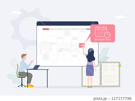 カレンダーを見ながらSNS投稿の予約をする広報担当者 127157786