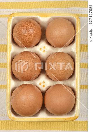Six brown eggs 127157885
