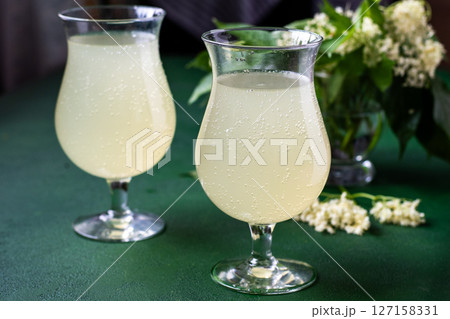 Carbonated elderflower cold drink. Flower summer kvass in glasses Carbonated elderflower cold drink. Flower summer kvass in glasses 127158331