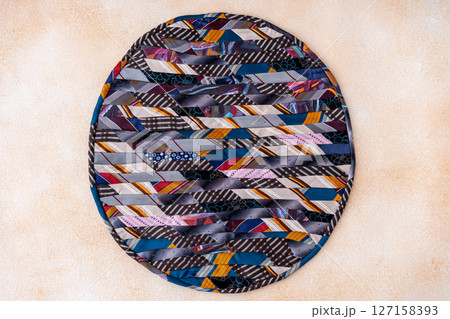 Patchwork rug. A fragment of colorful pieces of fabric sewn together. Patchwork rug. A fragment of colorful pieces of fabric sewn together. 127158393