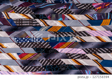 Patchwork Blanket. A fragment of colorful pieces of fabric sewn together. Patchwork Blanket. A fragment of colorful pieces of fabric sewn together. 127158394