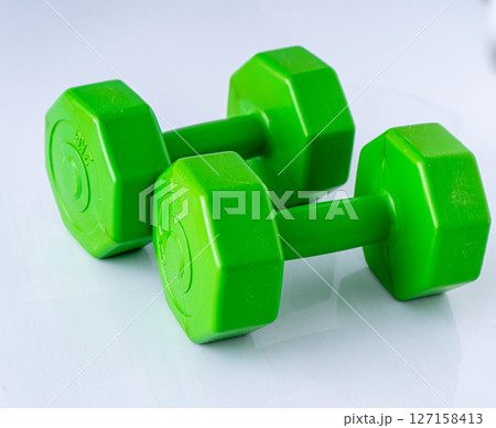 Two dumbbells 2 kg each. Sports equipment. White background. 127158413