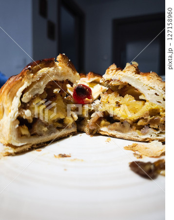 Nutty pastry slice revealing layered ingredients, golden brown crust with seasonal fruits, embodying traditional italian dessert from aosta valley Nutty pastry slice revealing layered ingredients, golden brown crust with seasonal fruits, embodying traditional italian dessert from aosta valley 127158960