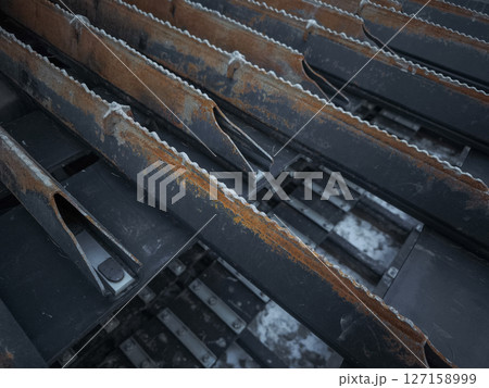 Close up of rusty metal structures with serrated edges, industrial decay and texture in aosta, italy during november Close up of rusty metal structures with serrated edges, industrial decay and texture in aosta, italy during november 127158999